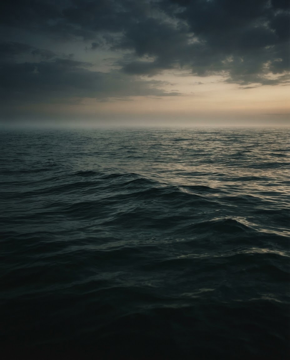The Gulf at first light, dark green water under low cloud.