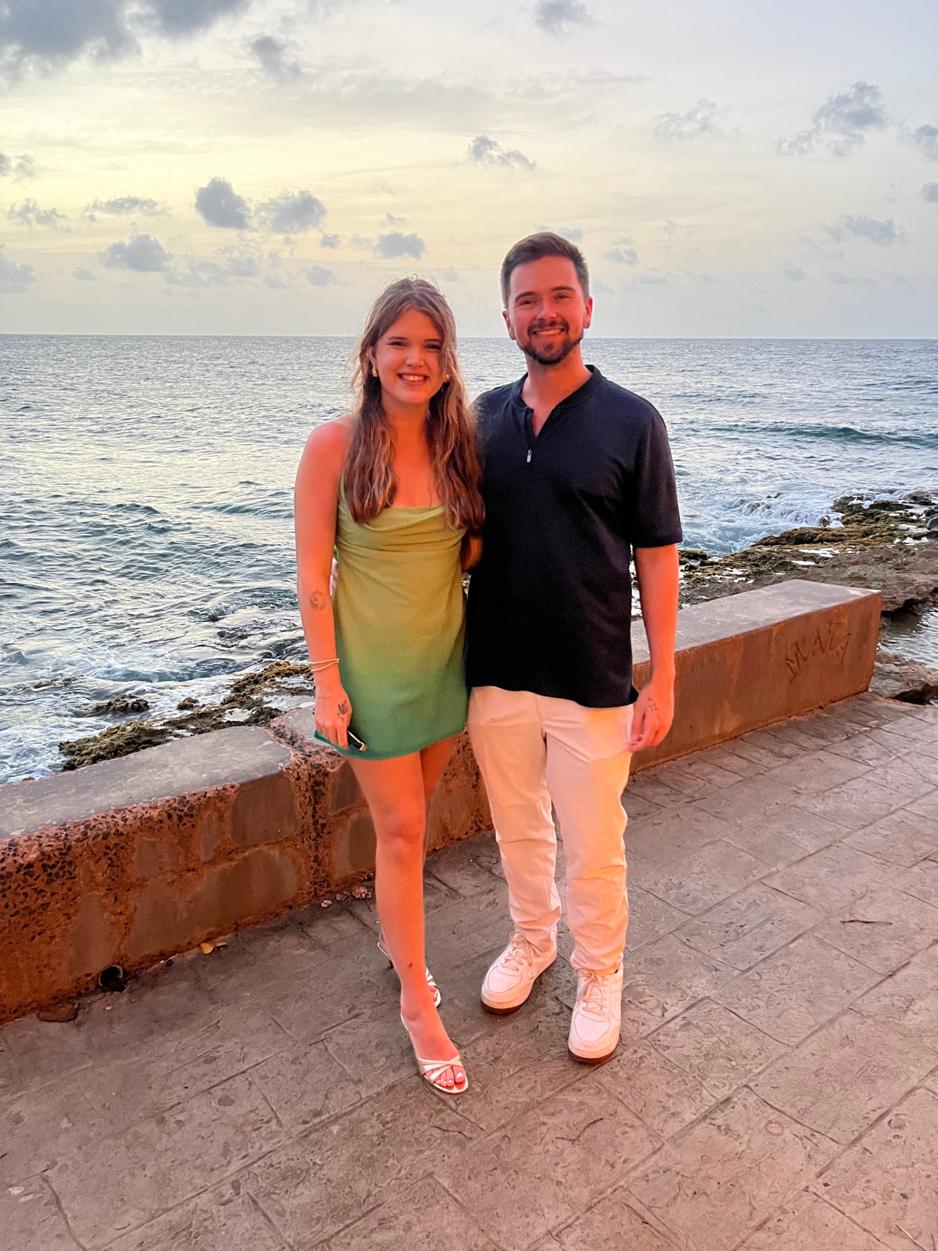 Aaron and his fiancée at sunset by the ocean